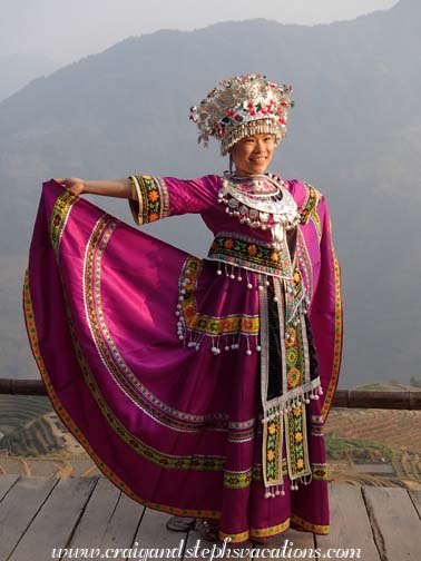 Our new friend gets photographed in traditional Miao clothing