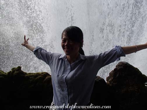 Chinese tourist enjoying the spray from Huangguoshu Falls Chinese tourist enjoying the spray from Huangguoshu Falls