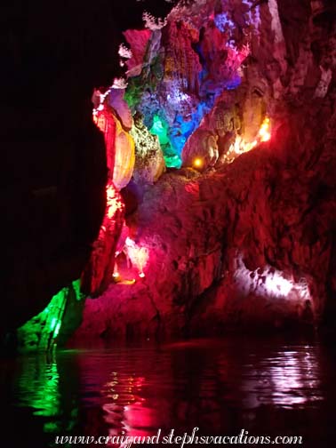 Stalactites lit up and reflecting in the water in the Dragon Palace Stalactites lit up and reflecting in the water in the Dragon Palace