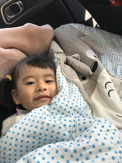 Ziting prepares for a nap in the car
