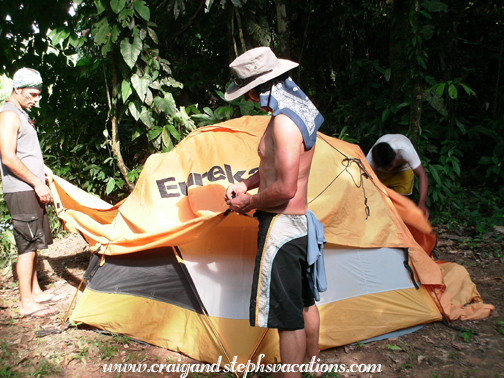 Setting up the tent in our wooded campsite