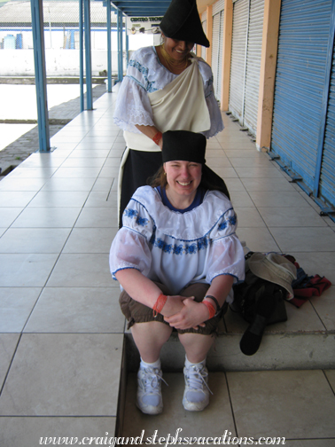 Steph sits down so that Rosa can reach her head