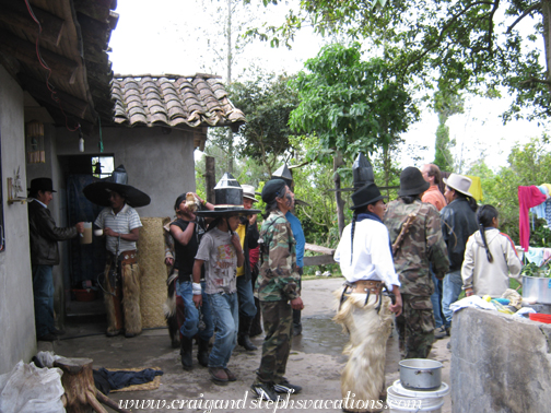 Inti Raymi dancers stop at the house for food and drink before marching to Cotacachi