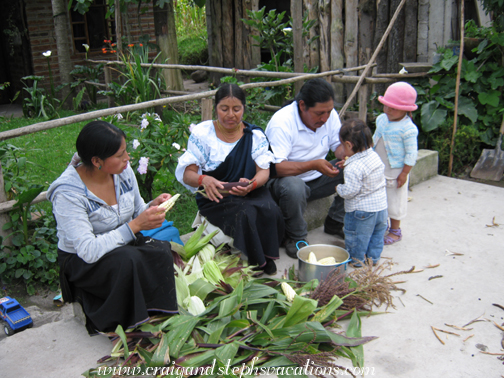 The family shucks corn