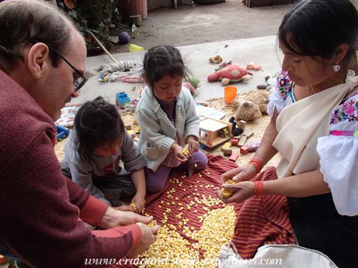 Craig, Yupanqui, Tayanta, and Rosa stripping dried corn kernels from the cobs to plant. Craig, Yupanqui, Tayanta, and Rosa stripping dried corn kernels from the cobs to plant.