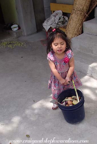 Tayanta takes the organic waste to the compost pile Tayanta takes the organic waste to the compost pile