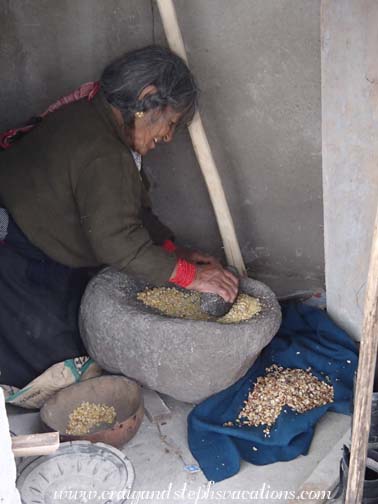 Abuelita grinds dried corn Abuelita grinds dried corn