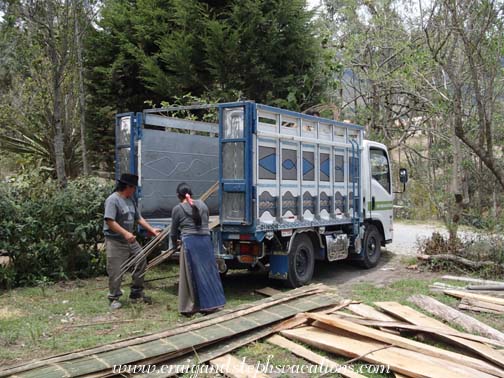 Antonio and Aida unload a delivery of rebar and bamboo