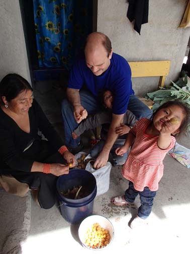 Rosa, Craig, and Tayanta peel uvillas