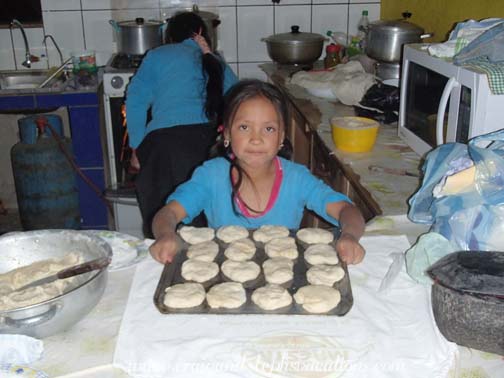 Sisa prepares to put the bread in the oven Sisa prepares to put the bread in the oven