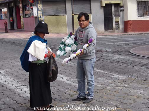 Man selling flowers to a woman for the cemetery Man selling flowers to a woman for the cemetery