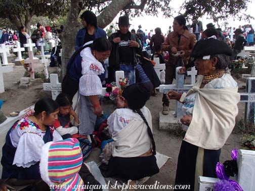 The family gathers in the Kichwa section of the cemetery The family gathers in the Kichwa section of the cemetery