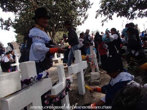 Woman offers food in the cemetery Woman offers food in the cemetery