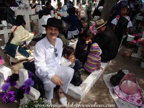 Craig sits with the kids on a family grave