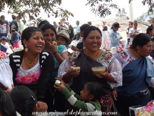 Women laugh and chat while they share food and drink at the cemetery