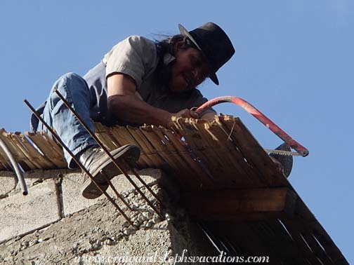 Antonio trims the ceiling bamboo