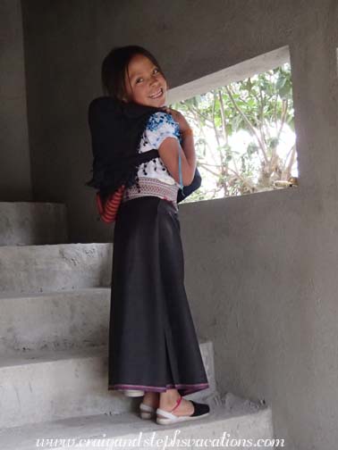 Sisa carries her doll on her back Sisa carries her doll on her back