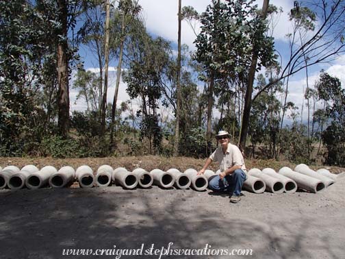 Craig poses with the sewer pipes that are ready to be installed Craig poses with the sewer pipes that are ready to be installed
