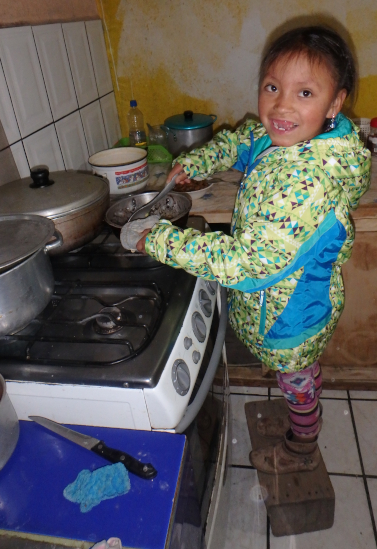 Sisa helps to cook dinner