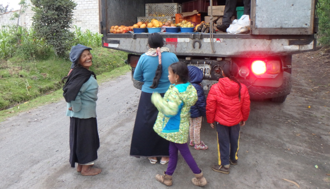 Abuelita, Rosa, and the kids buy fruits from the produce truck