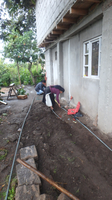 Antonio and Rosa laying pipe for the washing machine