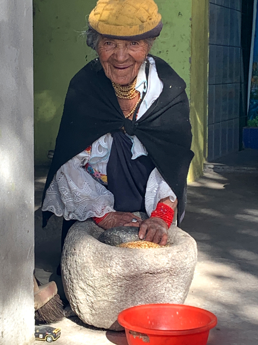 Abuelita grinding corn