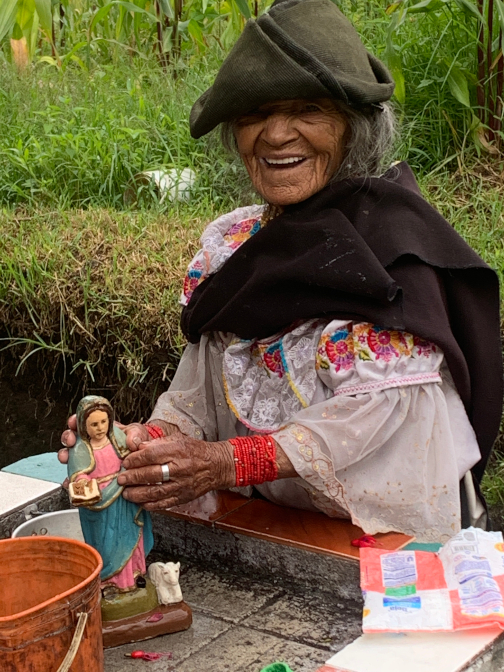 Abuelita cleaning her Virgin Mary statue