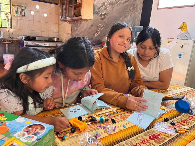 Nena, Shina, Sisa, and Aida assembling Legos