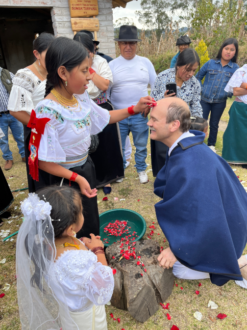 Shina cleanses Achi Taita's face with rose petals as part of the &Ntilde;awi Mayllay ritual