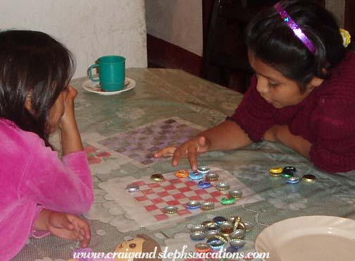 Yasmin and Paola play checkers Yasmin and Paola play checkers