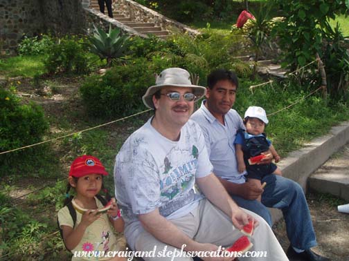 Aracely, Craig, Humberto, and Eddy enjoy watermelon by the lake Aracely, Craig, Humberto, and Eddy enjoy watermelon by the lake