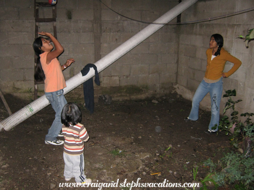 Paola and Vanesa play volleyball while Eddy watches Paola and Vanesa play volleyball while Eddy watches