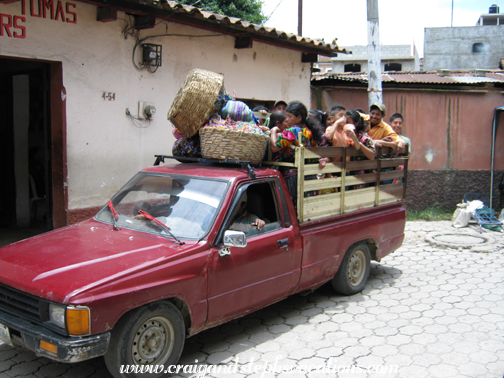 People packed into the back of a pickup People packed into the back of a pickup