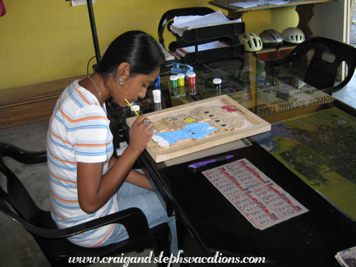 Vanesa paints her wood carving Vanesa paints her wood carving