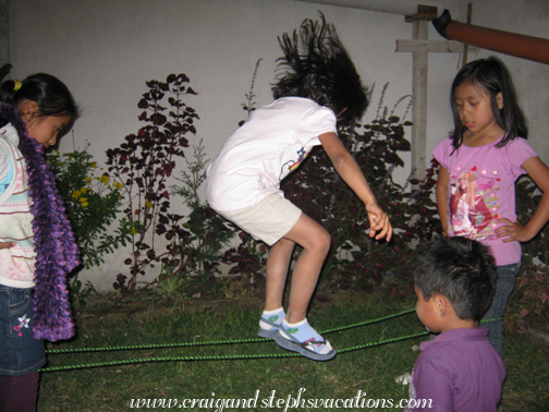 Aracely playing Chinese jumprope with Loren, Neli, and David Aracely playing Chinese jumprope with Loren, Neli, and David
