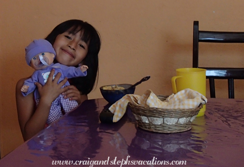 Aracely and her doll at breakfast Aracely and her doll at breakfast