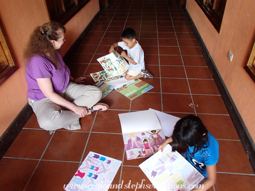 Steph, Aracely, and Eddy play with the sticker books Steph, Aracely, and Eddy play with the sticker books