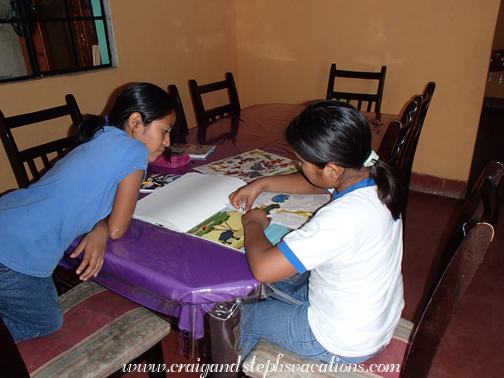 Yoselin and Yasmin play with the sticker books Yoselin and Yasmin play with the sticker books