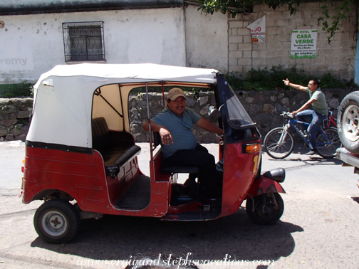 Carlos in his tuk-tuk Carlos in his tuk-tuk