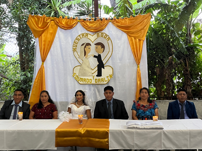 The bride and groom and their parents at the head table