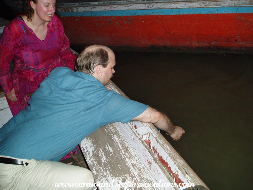 Lighting a candle and floating an offering into the Ganges