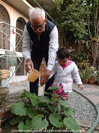 Sara helps Dadoo water his plants