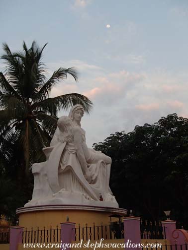 Moon over a replica of the Pieta outside a church Moon over a replica of the Pieta outside a church
