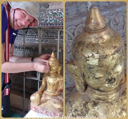 Steph affixes a shiny aquare of gold leaf to a Buddha statue in a cave at Phowin Taung