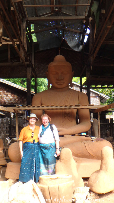 Dwarfed by a large clay Buddha form Dwarfed by a large clay Buddha form