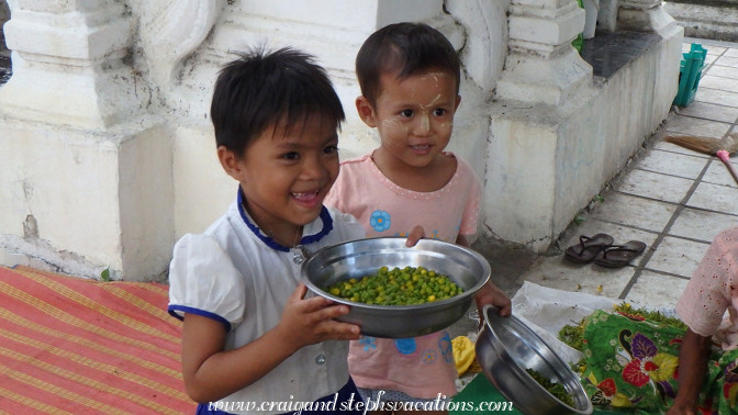 Little girls helping their mom to peel produce Little girls helping their mom to peel produce
