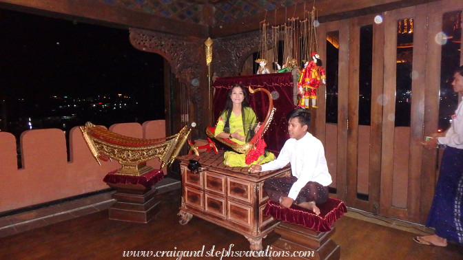Woman plays a saung (Burmese Harp) at Shwe Bagan Restaurant Woman plays a saung (Burmese Harp) at Shwe Bagan Restaurant