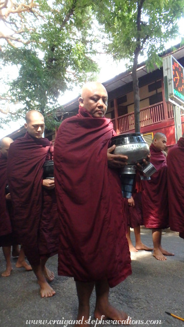 Monks queue for the last meal of the day at Mahagandayon Monastery