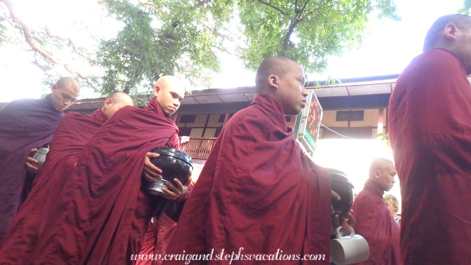 Monks queue for the last meal of the day at Mahagandayon Monastery