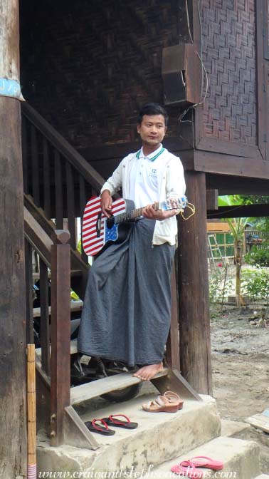A man with a guitar beckons us into the health clinic